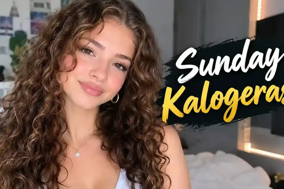 Sunday Kalogeras smiling with long curly brown hair and gold hoop earrings
